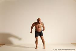 Underwear Gymnastic poses Man Black Muscular Bald Dancing Dynamic poses Academic